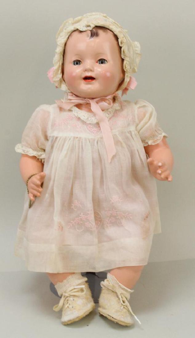 17 1/2" 1942 EFFANBEE "BABY LOVUMS" DOLL.: All original composition head, limbs with pink cloth body. Blue sleep eyes, open mouth, painted hair. Tagged dress; petticoat, bonnet and shoes. No panties. Brass heart bracelet. Stand. Condition: eye