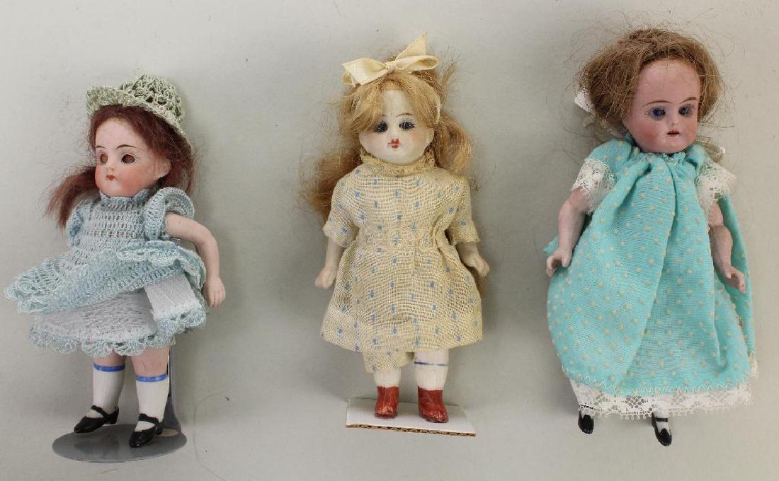 LOT OF (3) ALL BISQUE ANTIQUE GIRL DOLLS WITH GLASS: (1) Is wire strung, (1) peg strung, (1) strung. All have blue eyes, mohair wigs, painted shoes and are dressed. 5 Pc. bodies - 4 1/2" Made in Germany has sleep eyes. 4 1/2" 2/0 (chip on each hip). Swi