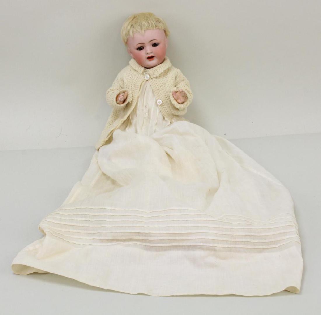 10" K*R SIMON & HALBIG 126 26 ANTIQUE BISQUE HEAD BABY: Brown sleep eyes, open mouth, blonde mohair wig. 5 Pc. papier mache bent limb baby body. Dressed in long antique baby gown and cotton petticoat. Knit cap, sweater and booties. Condition: nothing obser