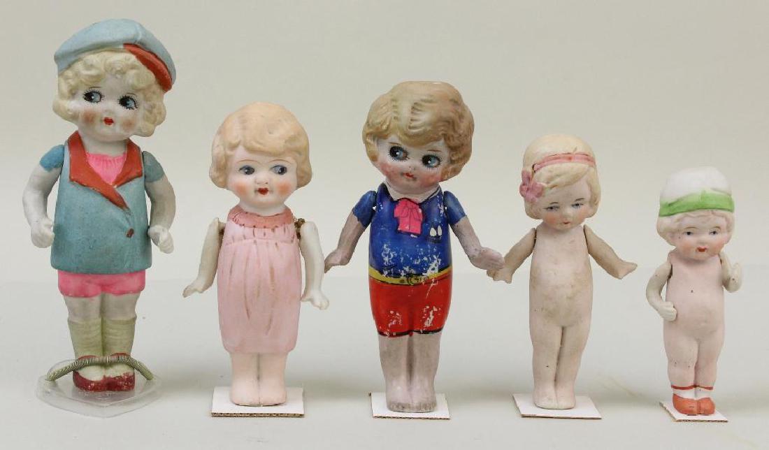 LOT OF (5) ANTIQUE ALL BISQUE DOLLS WITH PAINTED: All of the dolls have blonde hair, blue eyes. Strung arms only. 4 1/2" NIPPON, painted hat, shoes. 5 1/4" Unmarked, painted ribbon and bow in hair. 5 1/2" Made in Japan, painted clothing. 6" Made in J