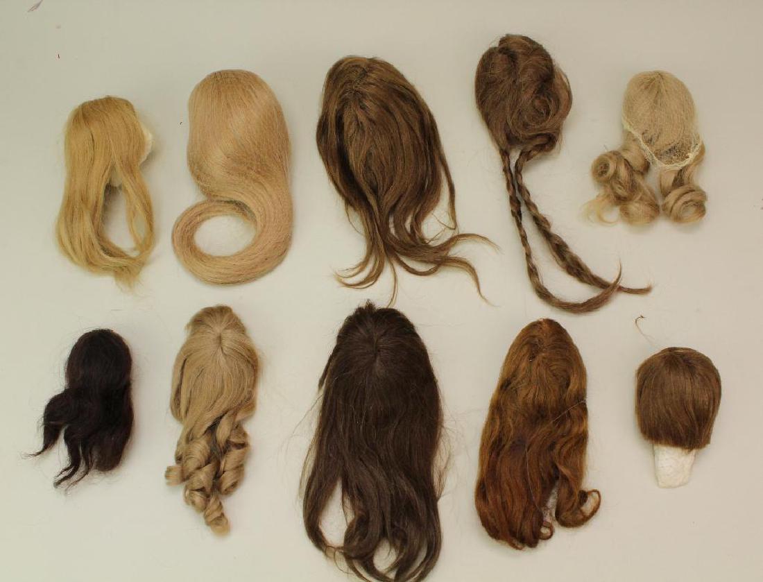 LOT OF (10) HUMAN HAIR DOLL WIGS.