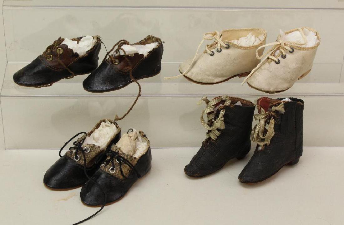 LOT OF ANTIQUE DOLL SHOES.: (4) Pairs. 2 3/4" Black oilcloth and faux snake "5" Made in Germany. 2 3/4" Ivory oilcloth lace up "6". 2 3/4" Black/brown oilcloth "5" Made in Germany. 2 1/2" Embossed black leather fashion boots wit