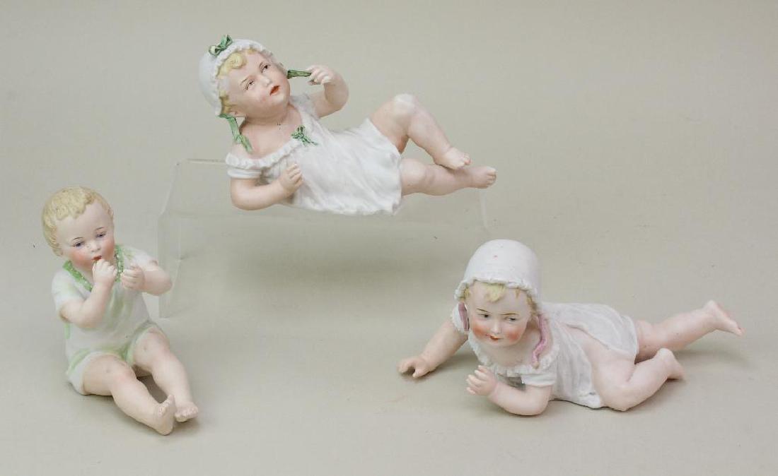 LOT OF (3) ANTIQUE PIANO BABY FIGURINES. (1 of 2)