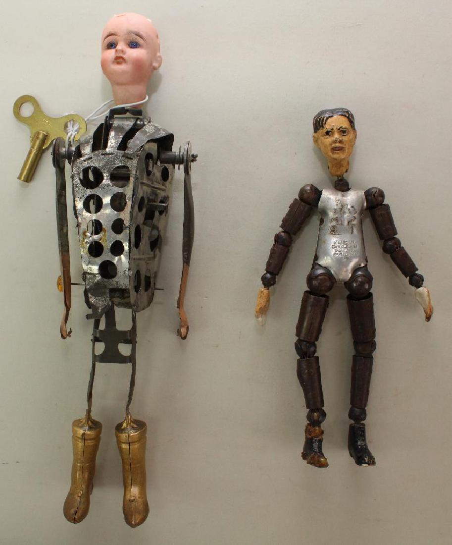 TOYS: SWISS BUCHERER CHARACTER AND ANTIQUE BISQUE HEAD: 8" Bucherer with composition head, hands and large feet. All metal body stamped: Made in Switzerland Patents Applied For. No clothing. Condition: damage/repair to back of head, both hands, right foot.