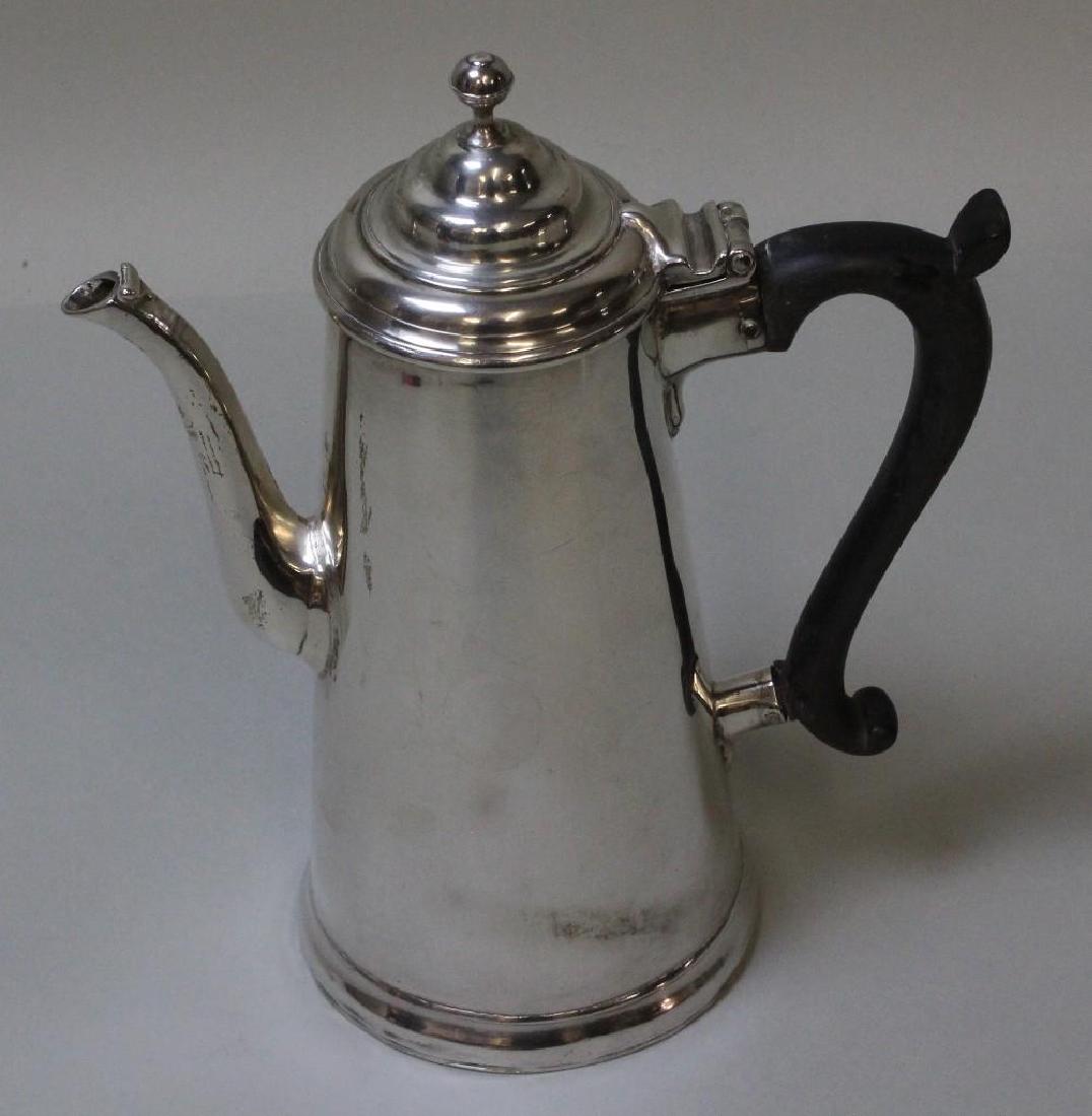 Georgian Sterling Coffee Pot: C. 1721. Hallmarks are largely illegible, but the date mark appears to be 1721. Typical tapered Georgian form, with ebony handle and ball finial. 8.75"H x 7.5"W. 17.6ozt