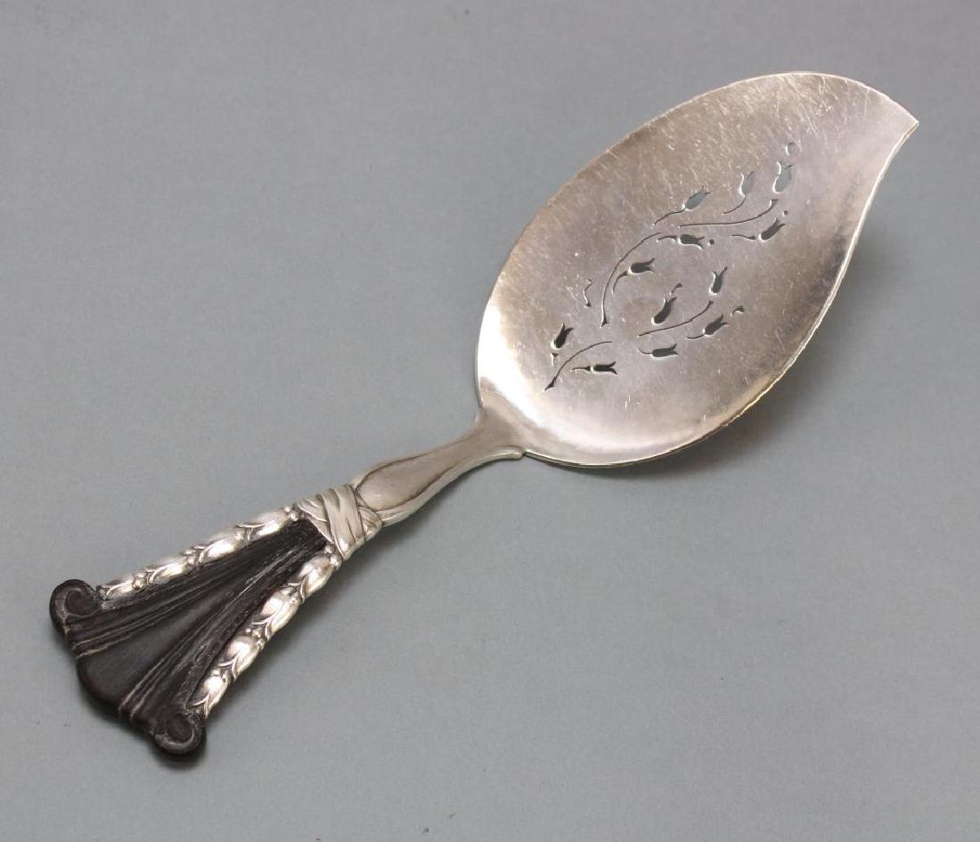 Georg Jensen Sterling Silver Fish Server: 1915-1927. Inlaid ebony handle, pierced blade. 10"L. 5.28ozt