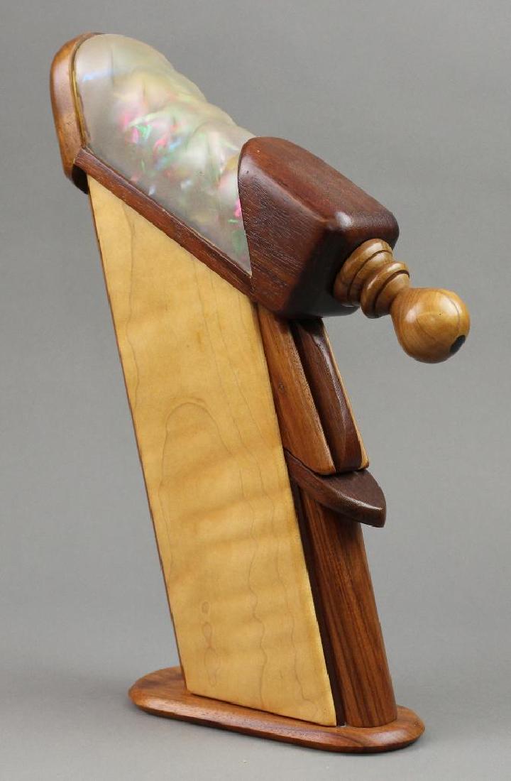 Michael Redmond Kaleidoscope: Michael Redmond, 1996. Wood slanted column with wooden knob. Fabric and ribbon viewing objects. 13"H