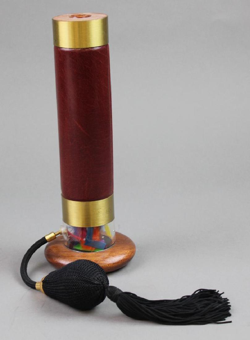Paretti Kaleidoscope: "Feather and Leather". Verdi by Paretti. Cylinder shape wood with leather and brass. Squeeze ball/atomizer moves viewing components. 10"H