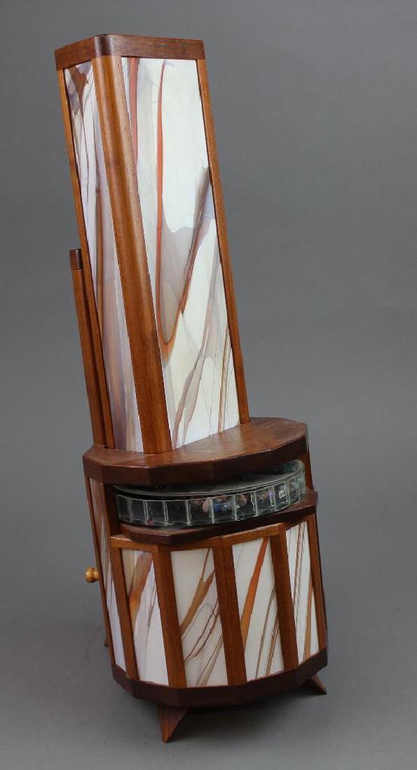 Luc and Sally Durette Kaleidoscope: "Aurora" by Luc and Sally Durette. #8/25. 1993. 2 piece wood and laminate triangular on leaning hexagonal drum base. Large open viewing container. Kaleidoscope 13"H. Total with base 19"H