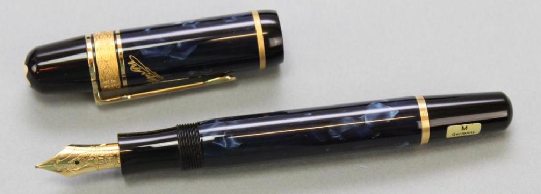 Mont Blanc Edgar Allan Poe Fountain Pen: 1998, Germany. Original shipping and presentation boxes, dark blue marbled resin cap and barrel that bear a gilded signature. 18k nib with etched raven, fine.