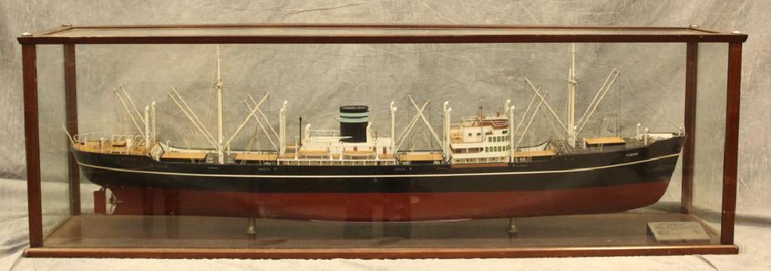 Motor Cargo Ship "Tudor" Model Ship: This ship was built by Kockums Mekaniske Verkstad and owned by Wilh. Wilhelmsen, in Oslo, Sweeden. This ship featured a speed of 17 knots and a deadweight of 9090 tons. In a case that measures 18.5" (