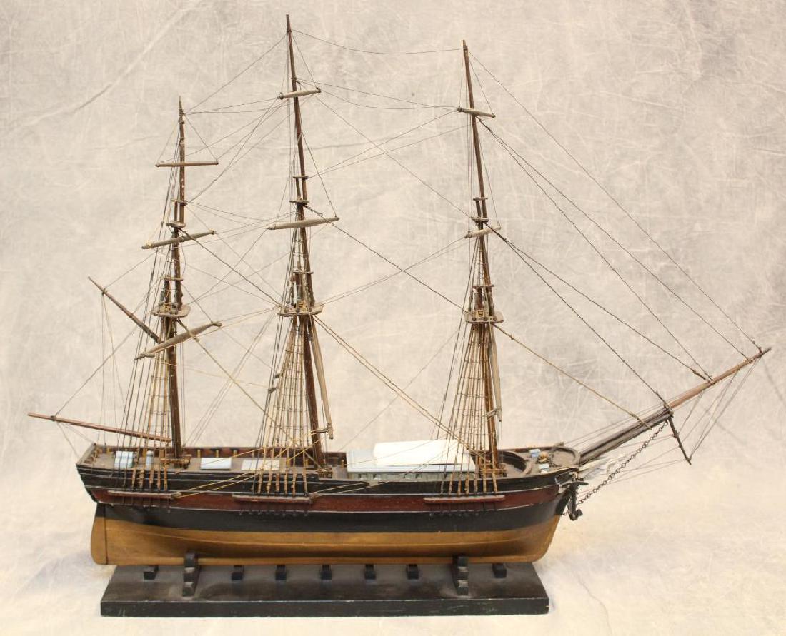 Merchant Sailing Model Ship: Wooden ship model of unknown American 19th century, 3-masted merchant sailing ship. Ship displays full rigging and no sails and measures 25" (H) x 33" (L) x 13" (W). The ship presents two small boats