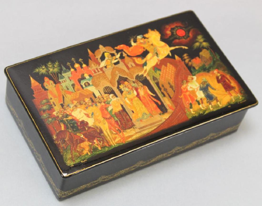 Palekh Russian Black Lacquer Box: Black hinged lacquer boxes with red interior, signed and dated. Painting depicts the Sivka Burka tale, includes Palekh receipt and tag. 1.75"H x 6.5"W x 3.75"D