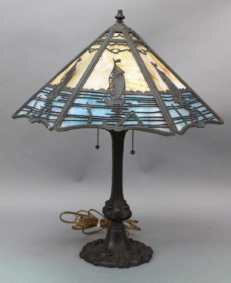 Slag Glass Lamp: (6) panel caramel and blue with sail boat motif. Unsigned, 20"H x 18"W