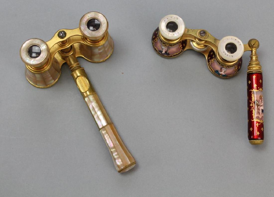 French Enamel and Mother-of-Pearl Opera Glasses: Faceted mother of pearl veneer and a central handle with a built-in focal wheel, signed Lemaire Paris. Red enamel with hand painted portraits, putti and fleur de lis. Enamel has some cracking and los