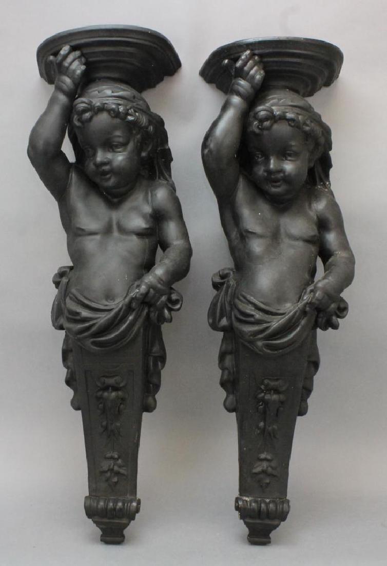 Figural Wall Sconces: Pair of black painted plaster putti wall sconces. 31"H x 9.5"W x 7"D