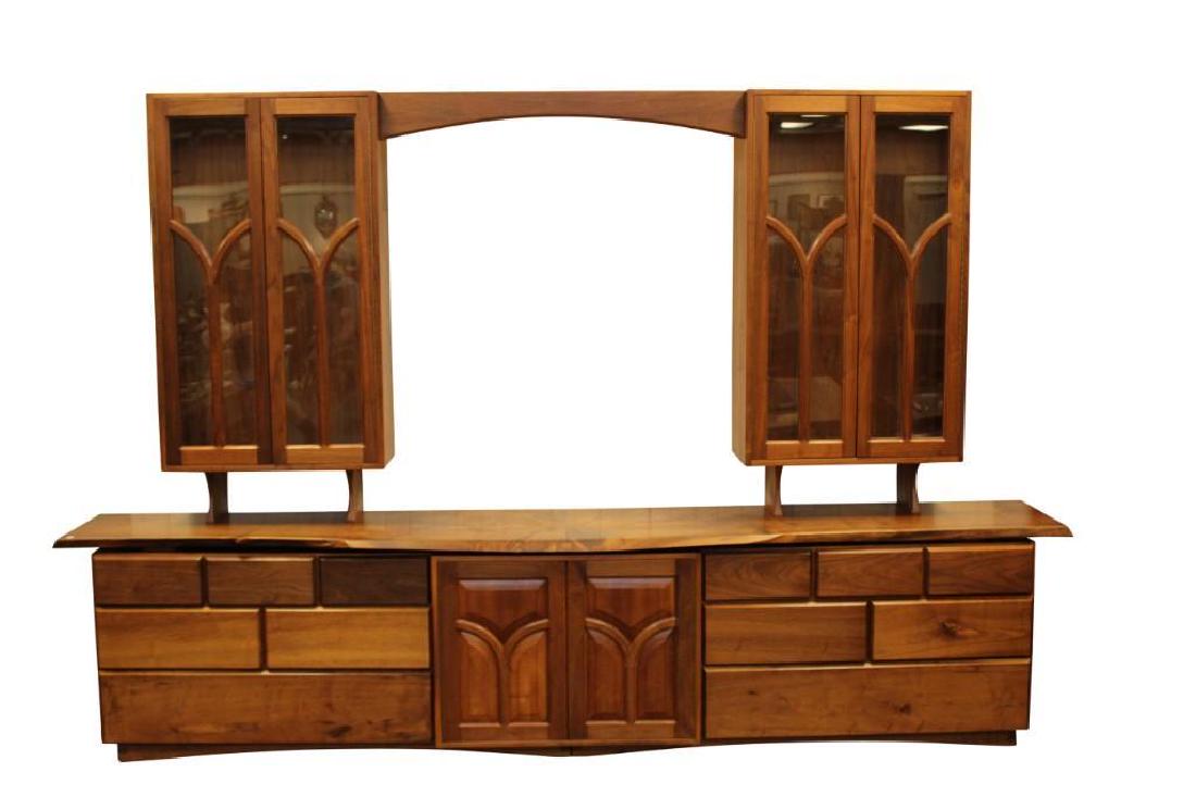 Alan Rockwell, Live Edge Wall Unit: Alan Rockwell, New Hope, Pa, walnut live edge wall unit with 2 glass 2 door cabinets over a sideboard of 12 drawers and 2 doors. Measures 134"L x 89"H x 18"W.
