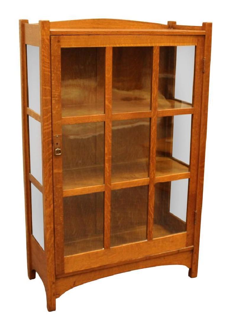 Stickley Bookcase: Mission oak single door bookcase with three interior shelves, measuring 54"H x 34"W x 15"D. Burn stamped L & JG Stickley (brothers Leopold and John George).