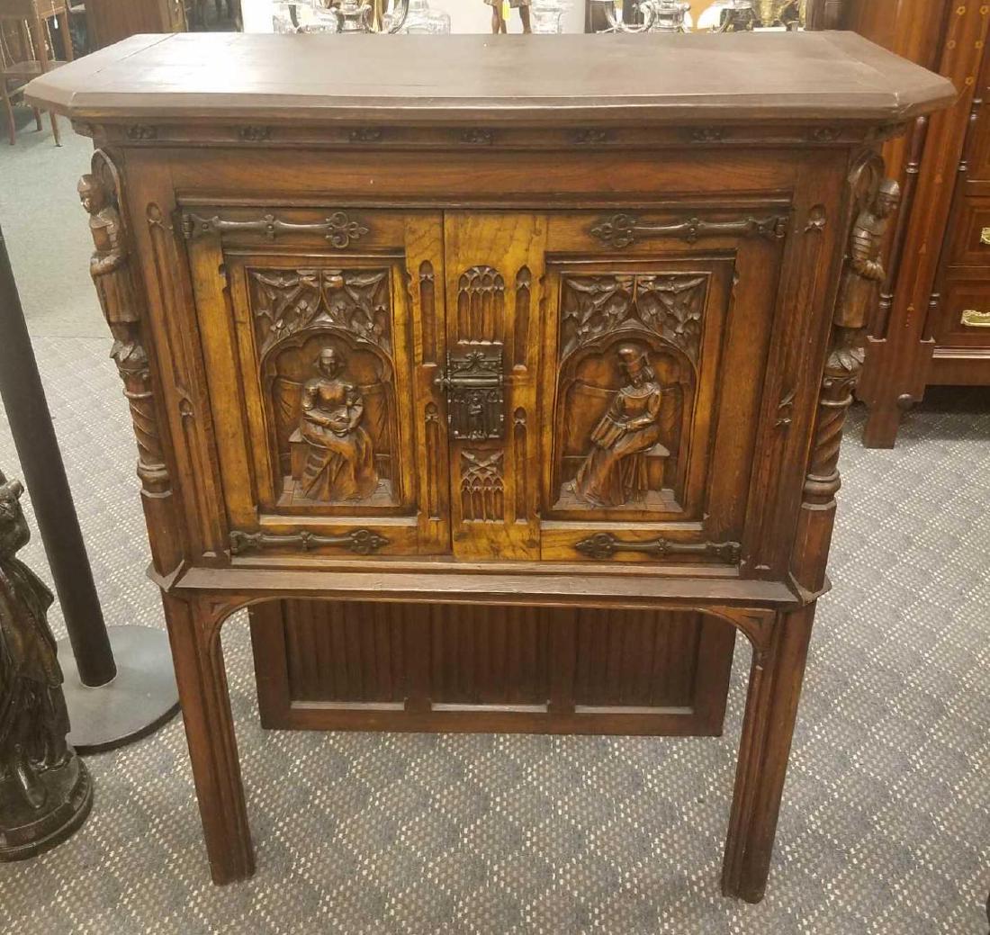 Gothic Carved Liquor Cabinet: Gothic carved cabinet with figural and portrait carvings. 37"w x 17"d x 47"h.Â