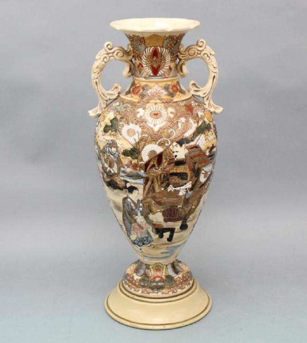 Satsuma Vase: Double handled, cream colored with figural depictions of warriors, a teacher and student. Bronze and gold outlines with dark red and blue tones. 20"h