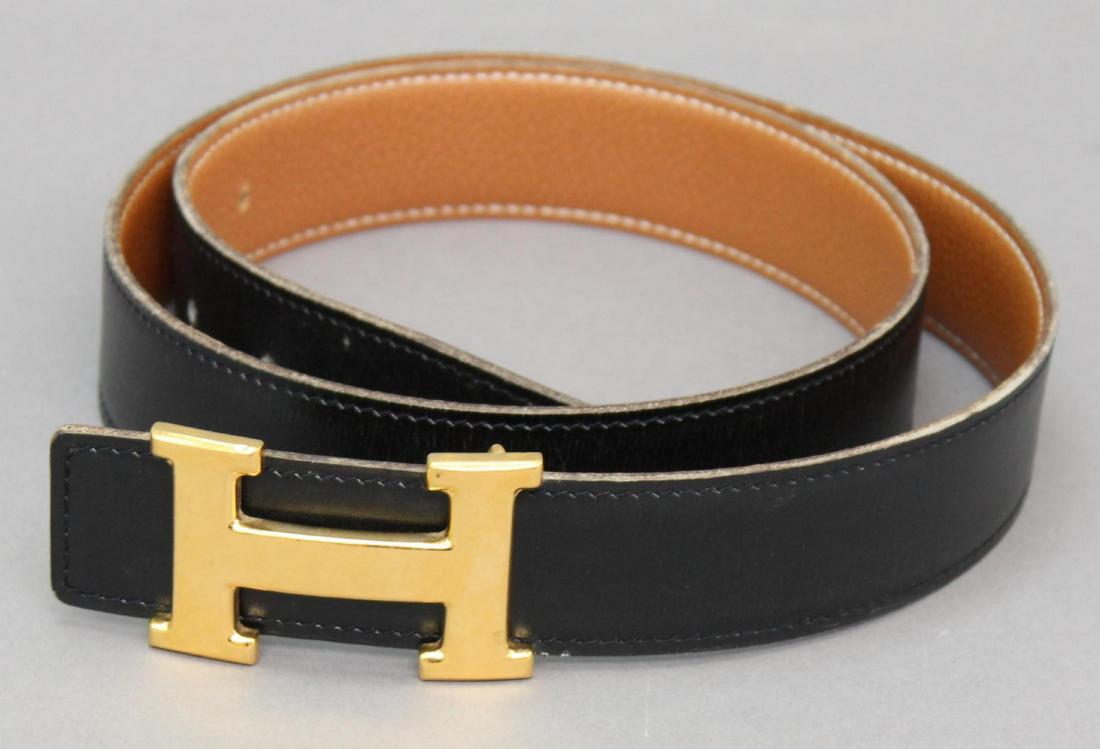 Hermes Belt and Buckle: Reversible black and natural leather. Both buckle and belt hallmarked. 1.25"H x 38"L