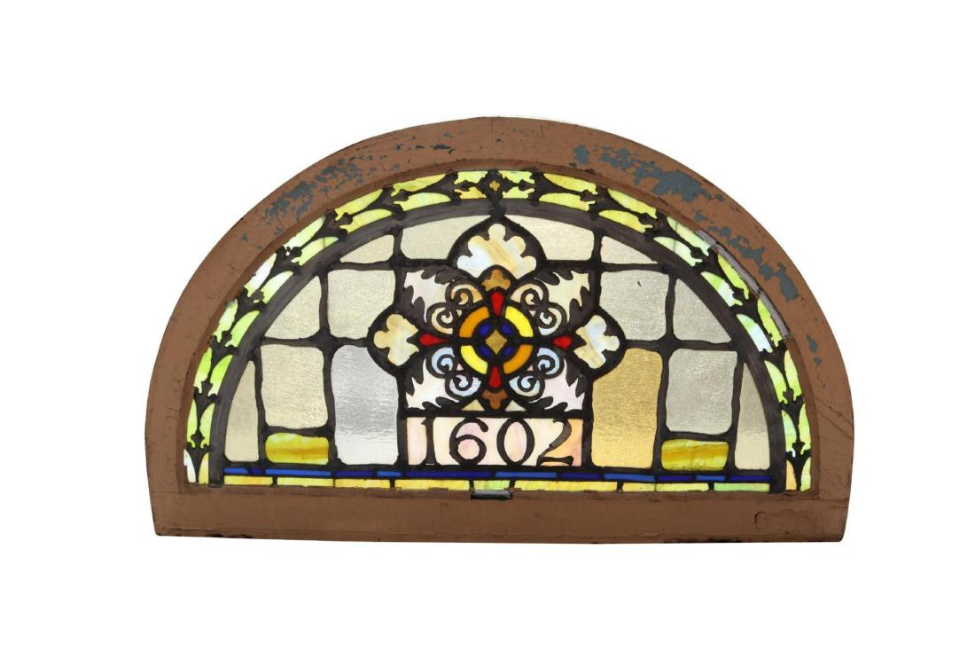 Stained Glass Window: Cathedral and stained glass window in demilune shape with cross or compass motif. 27"H x 46"W