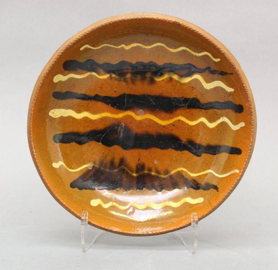 Slip Decorated Redware Plate: Alternating cream and black linear decoration. Not signed. 8"Round