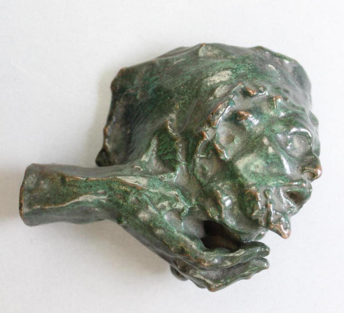 After Auguste Rodin (1840 - 1917): Bronze applied verdigris, a hand holding the severed head of John the Baptist. Cast into the flat portion of underside text reading "To Watty with love from Etta". Etta Wedell Mastbaum (1886-1953) was