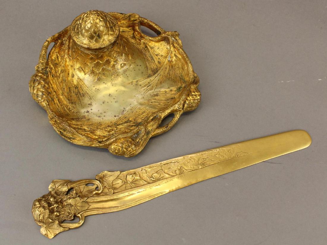Albert Marionnet Art Nouveau Letter Opener and Inkwell: 19th c. French dore bronze letter opener with the head of Bacchus and foliate decoration and inkwell and pen rest with pinecone motif. Both signed. 12.75"L x 2.25"W