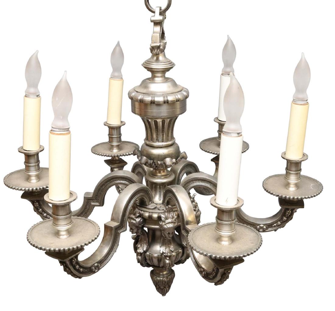 French Silver on Bronze 6 Arm Chandelier: Classical figural and bell flower decoration with a drop pendant, 30”h x 24”w.