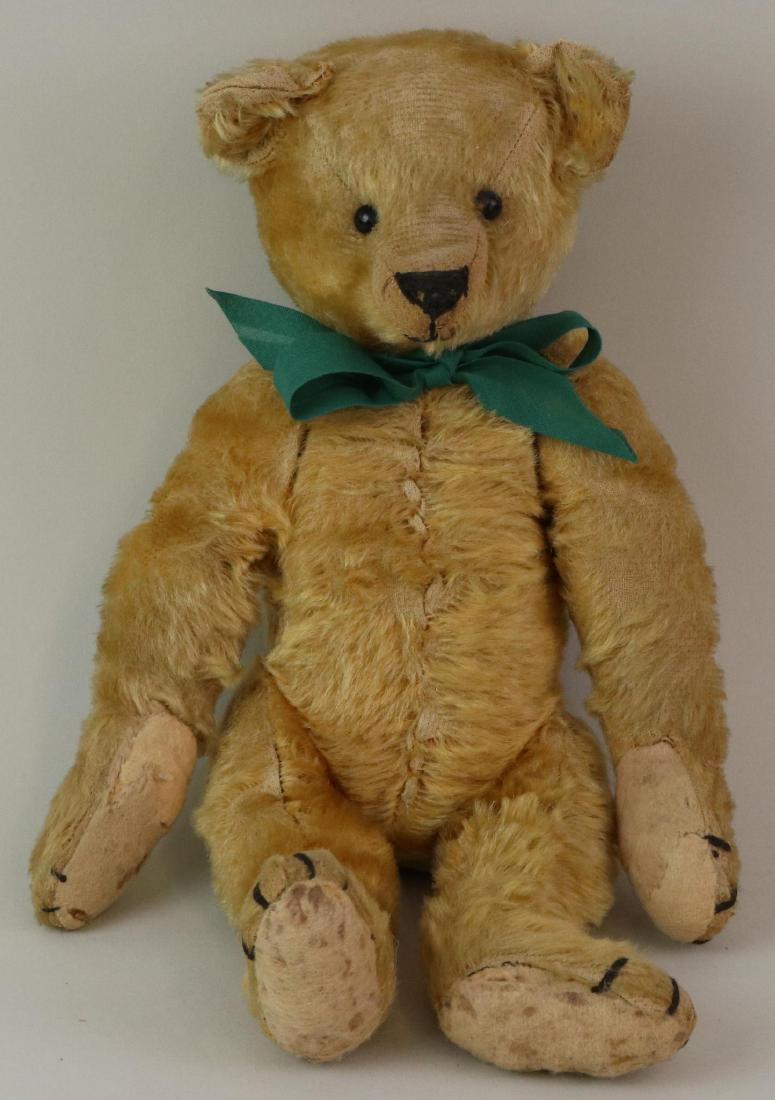 14 1/2" UNMARKED ANTIQUE MOHAIR TEDDY BEAR.: Gold mohair bear with black shoe button eyes. Elongated snout. Fully jointed with swivel head. Camel felt pads. Condition: overall wear to mohair. Upper pads have both been repaired by sewing. Lower p