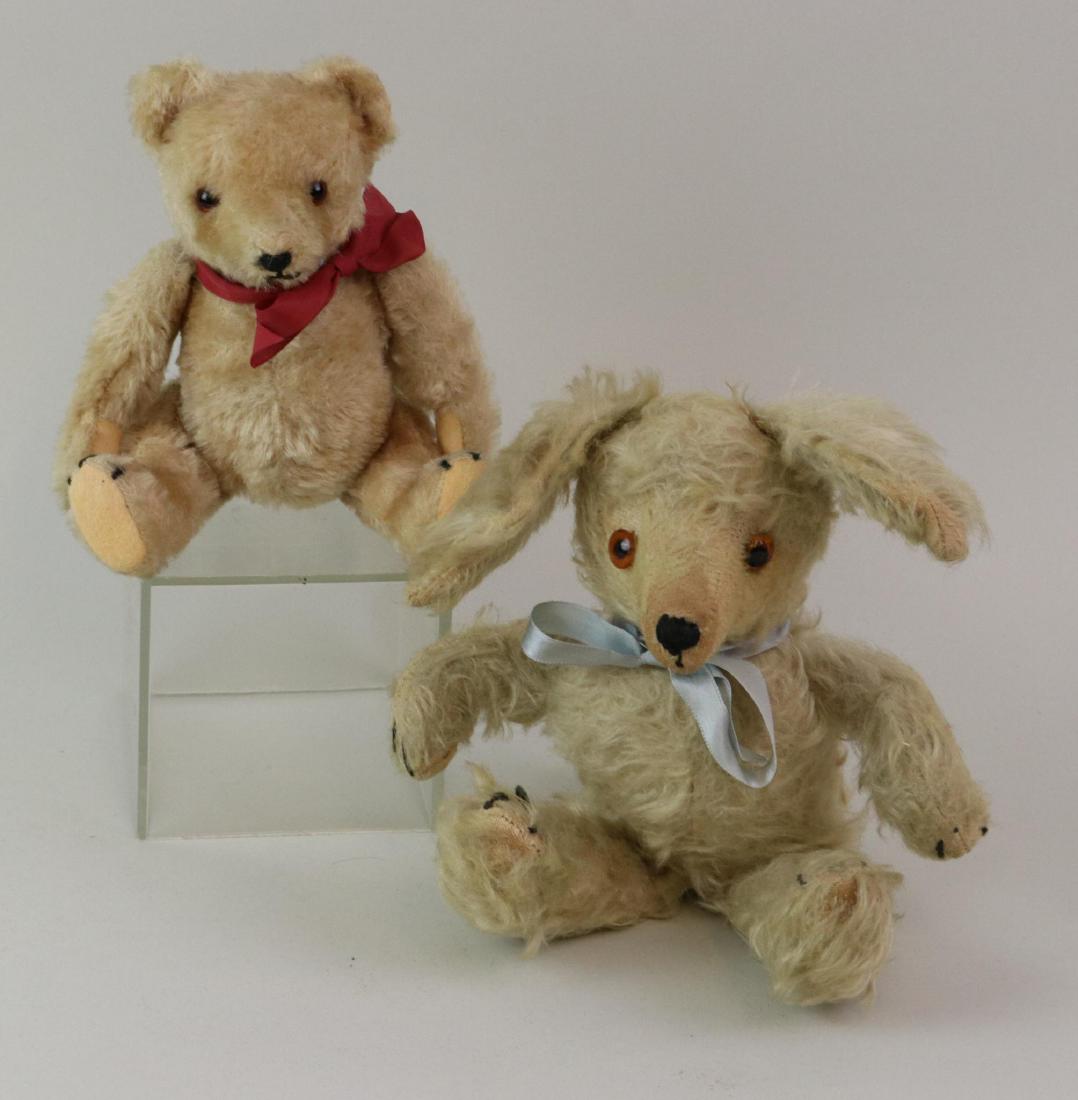 PAIR OF ANTIQUE MOHAIR ANIMALS.: 8" Unmarked Steiff camel mohair teddy bear with amber glass eyes. Fully jointed with swivel neck, elongated snout, camel felt pads. 10 1/2" Pale gray/dirty white mohair dog with elongated snout, amber