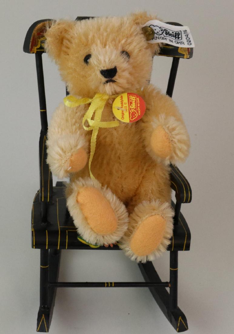6" TAGGED STEIFF MOHAIR BEAR IN CHAIR.: Camel fully jointed Original Teddybar Ltd. Ed. 82. Swivel head. Apricot felt pads. Tag reads: Made in West Germany LTD ED 82. Brass incised button. White cloth tag 0204/16. Bear is sitting on a 6" PA 