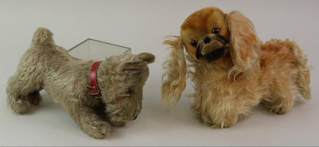 PAIR OF VINTAGE UNMARKED STEIFF MOHAIR DOGS.: 9" L. Long gray mohair "Tessie" Schnauzer with brown glass eyes, swivel head. Original red leather collar. 12" L. Apricot Pekinese with brown glass eyes, swivel head. Condition: both dogs have age los