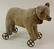 11" L. UNMARKED ANTIQUE MOHAIR BEAR ON WHEELED BASE.