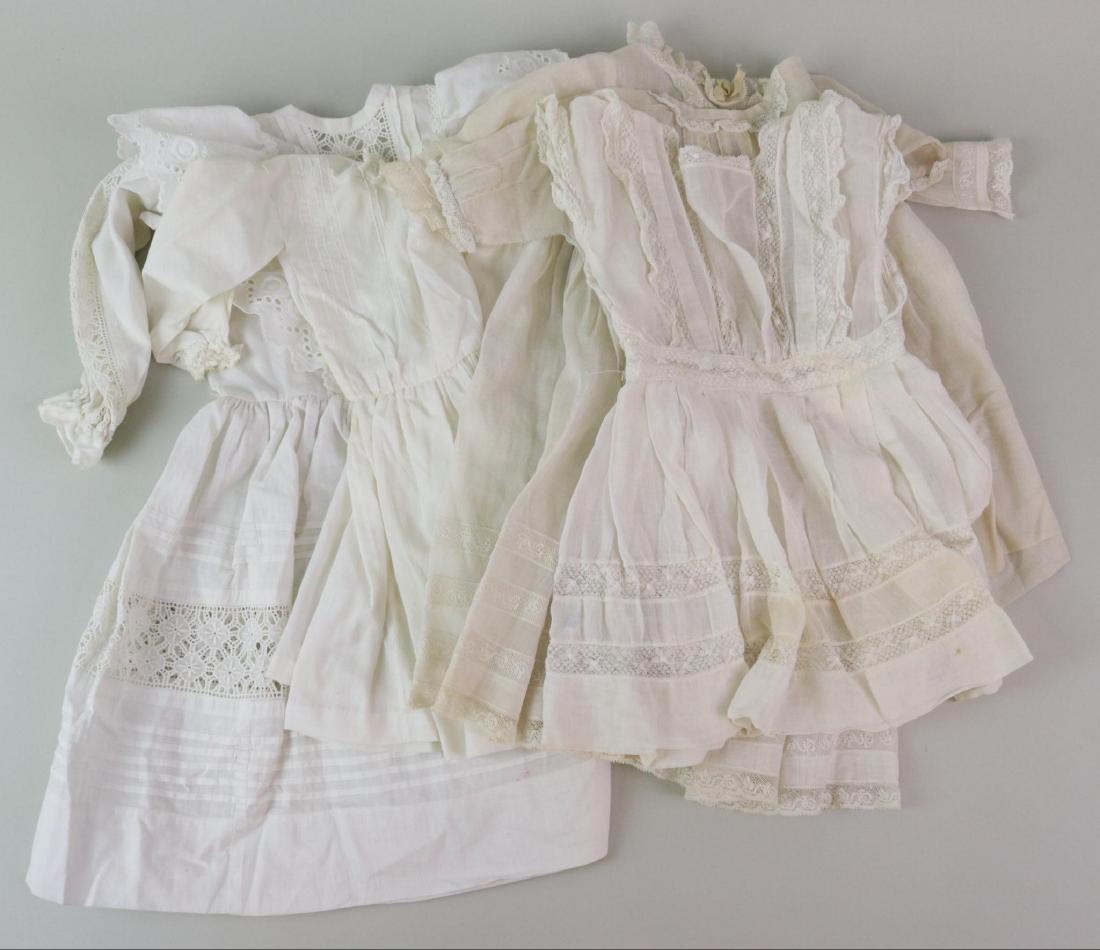 ANTIQUE/VINTAGE DOLL CLOTHING.: Lot of (5) antique/vintage white cotton dresses. Antique - 13 1/2", 15", 18". Vintage (made from antique fabric) - 14 1/2", 20". Condition: some age loss. This lot is being sold AS IS.