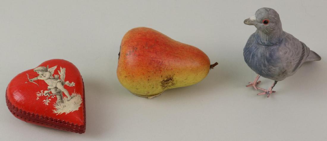 LOT OF HOLIDAY/NOVELTY ITEMS.: Lot of (3) antique papier mache candy containers. 3 1/2" L. Red/yellow "Pear". 5 1/2" L. Gray "Pigeon" with pink metal feet. 3" L. Red "Heart" with cherub decoation. Condition: some age loss to paint 