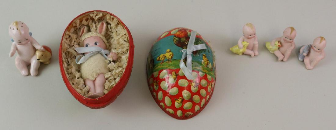 LOT OF KEWPIE.: Lot of antique all bisque/china Kewpie figurines, mostly Easter related. All bisque - 4" Kewpie in papier mache German egg. She is dressed in costume with rabbit ears. Pair of 2" Action Kewpies that a