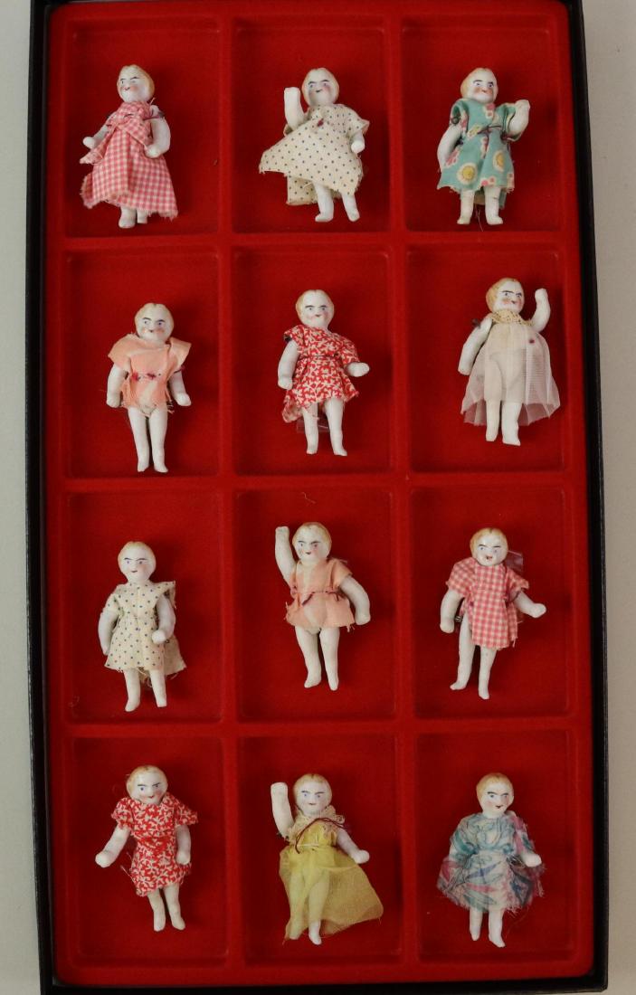 LOT OF MINIATURES/DOLLS.: Lot of (12) 2 1/2" wire strung parian type dolls with painted features, blonde hair. All have a little dress on them. Condition: nothing observed on dolls themselves. This lot is being sold AS IS.