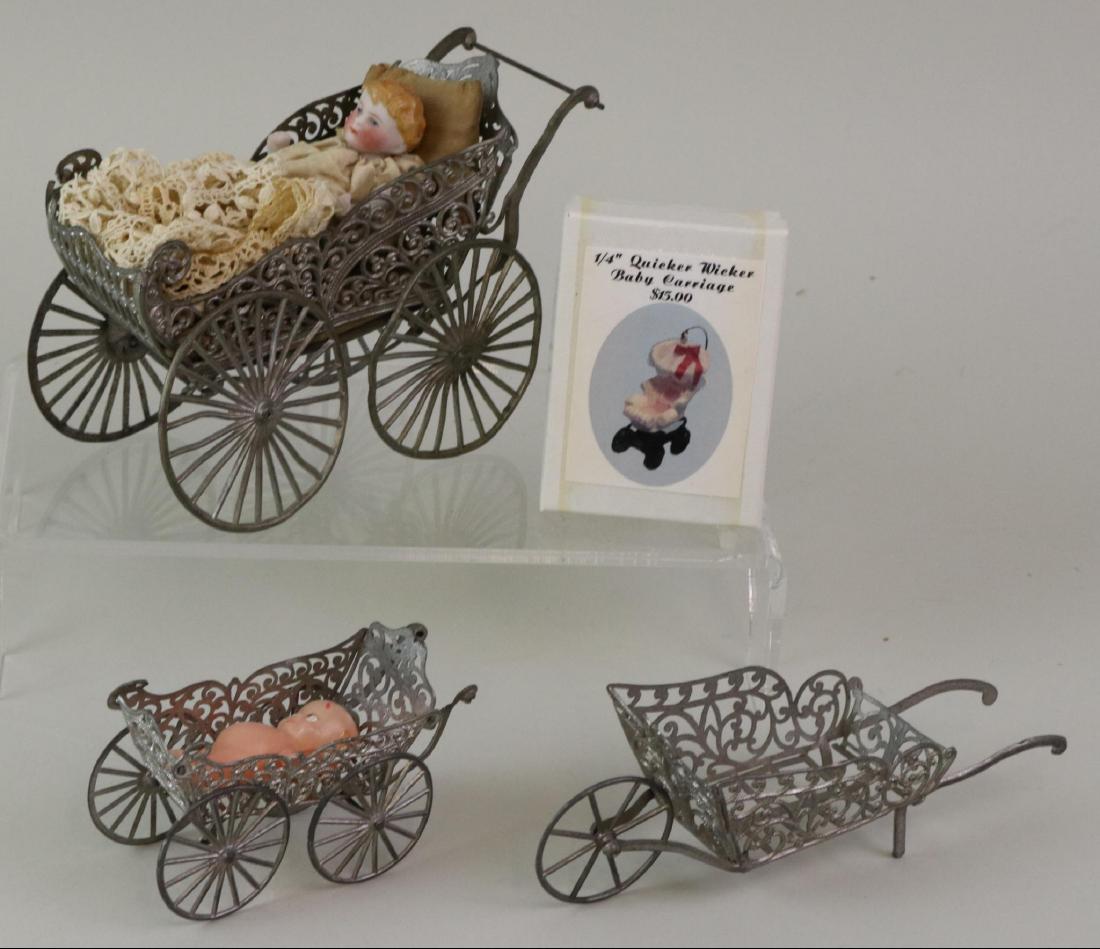 LOT OF MINIATURES/DOLLS.: Lot of (3) white metal carriages, wheel barrel. Carriages - 6" L x 4" T. All bisque doll in carriage is only a prop (and has loss, replaced leg). Condition: carriage is missing umbrella, age loss. 3 1