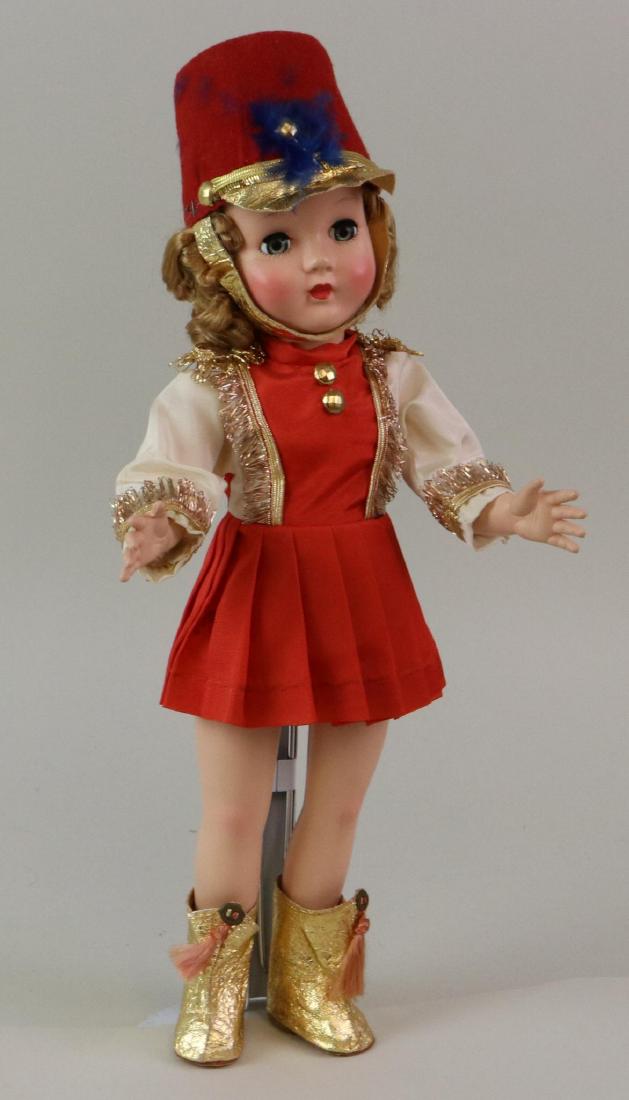 14" ALL ORIGINAL 1949-1955 EFFANBEE "HONEY MAJORETTE": Doll has curly reddish floss hair (uncombed), sleep eyes, closed mouth. Original red/white tafetta majorette costume with gold braid trim. Red felt hat with gold trim. Gold foil boots. NO baton. Stand