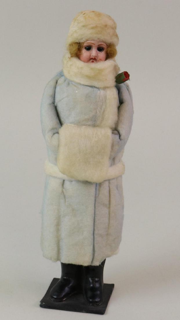 LOT OF HOLIDAY/NOVELTY ITEMS.: 9 1/2" Antique German lady papier mache candy container with bisque head, stationary eyes. Dressed in blue cotton batting coat with white muff, belt, hat. Painted black boots. Condition: minor age dis