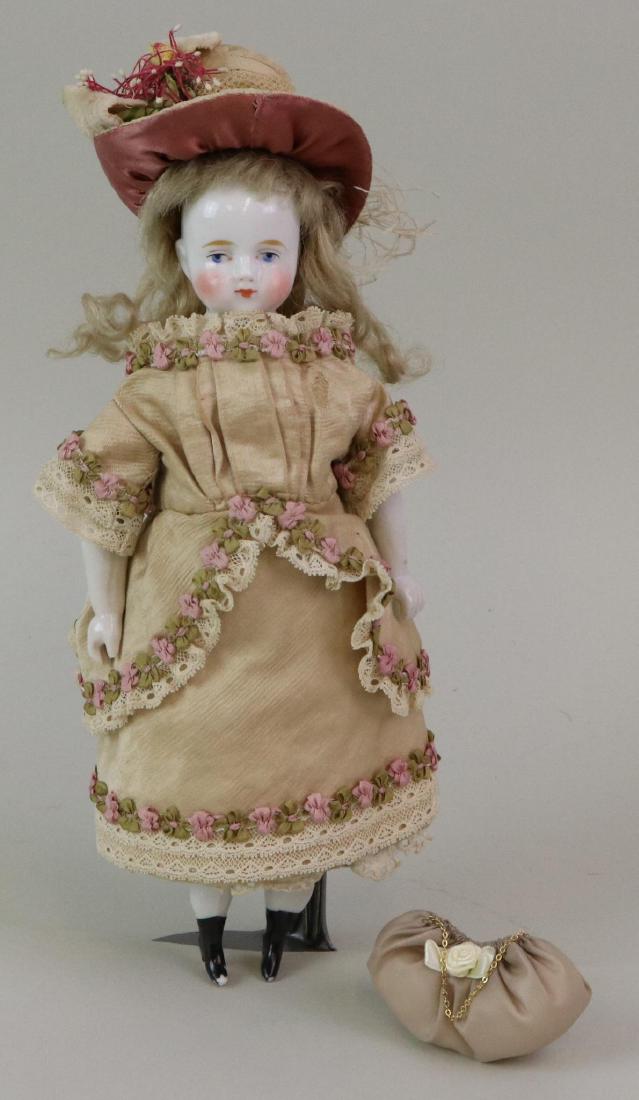 LOT OF CHINA/PARIAN DOLL(S).: 9 1/2" Antique unmarked bald head china with black area on top, honey blonde mohair wig. Blue eyes. Cloth body with china lower limbs, heeled boots. Dressed in antique clothing. Newer handbag, decorat