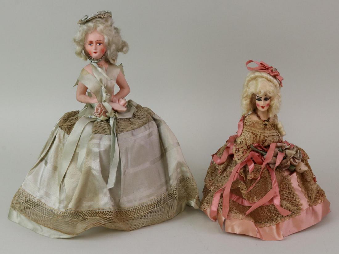 LOT OF HALF DOLL(S).: Pair of half dolls with papier mache heads. Both of them have mohair wigs and are mounted on bases. Dressed in antique silk, lace and ribbon trimmed dresses. 8" Doll has the more elaborate wig of the 