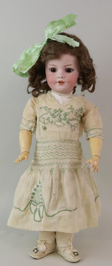 ANTIQUE BISQUE HEAD GERMAN DOLL.: 21" S & H 1279 DEP Germany 11 1/2 with brown sleep eyes, open mouth, pierced ears, brown curly mohair wig. Papier mache ball jointed body. Dressed in antique cotton clothing: voile dress with embroder