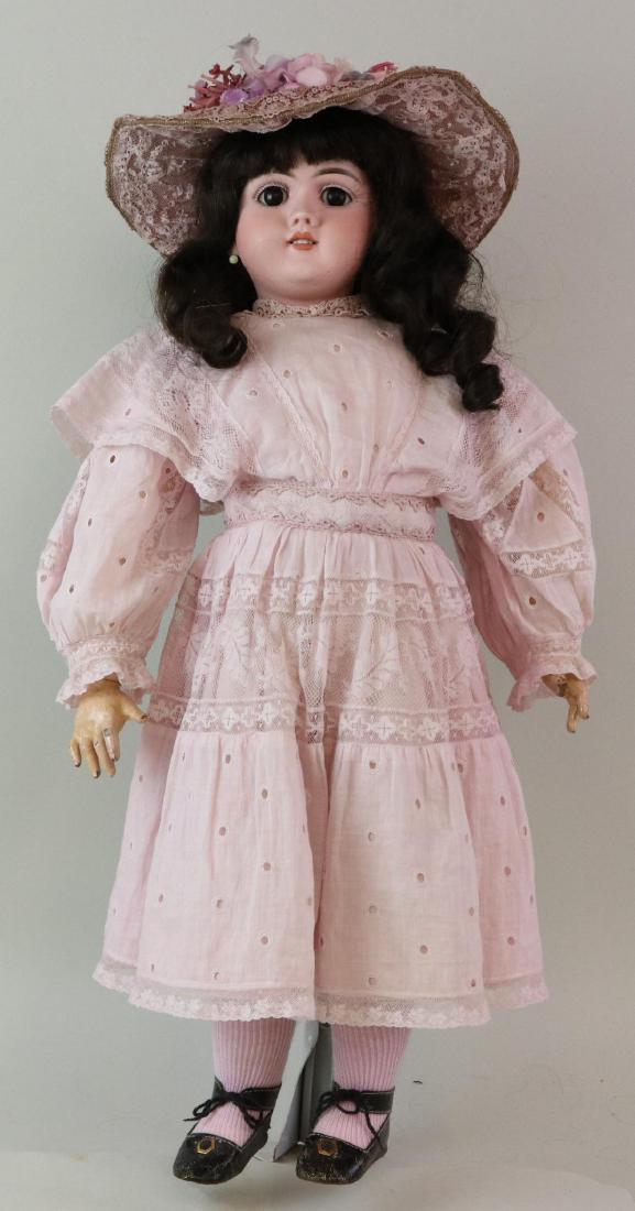 ANTIQUE BISQUE HEAD GERMAN DOLL.: 24" 13 99 DEP with brown sleep eyes, open mouth, pierced ears, dark brown curly human hair wig. Very clean unmarked French style papier mache jointed body. Dressed in reproduction lavender eyelet/lace