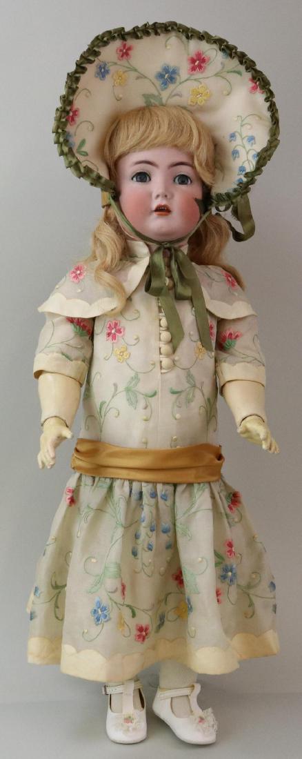 ANTIQUE BISQUE HEAD GERMAN DOLL.: 28 K * R SIMON & HALBIG 117n with blue flirty eyes, open mouth, long blonde human hair wig. Papier mache ball jointed body. Dressed in newer silk organza embroidered dress with matching bonnet. Cotton