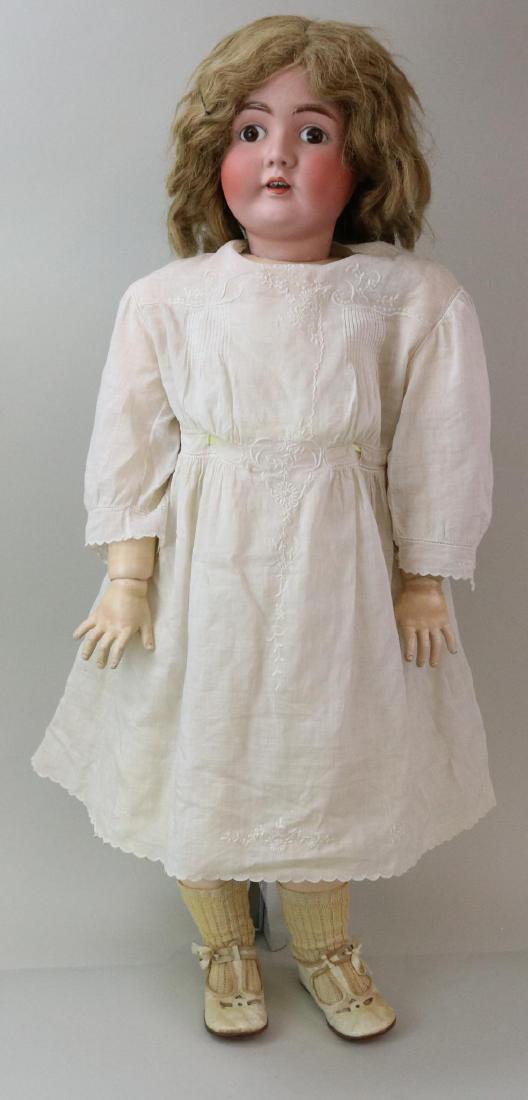 ANTIQUE BISQUE HEAD GERMAN DOLL.: 35" 0 1/2 Made in Germany 18 1/2 142 with stationary brown eyes, open mouth, light brown human hair wig, plaster pate. Very clean papier mache ball jointed body. Dressed in antique child's white cotto