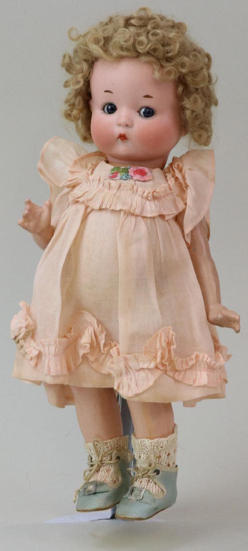 ANTIQUE BISQUE HEAD DOLL(S), 12" AND UNDER.: 12" "JUST ME" Registered Germany A.310/0.M. with blue side glance sleep eyes, closed mouth, curly honey blonde mohair wig. 5 Pc. papier mache body. Dressed in attractive reproduction cotton dress with