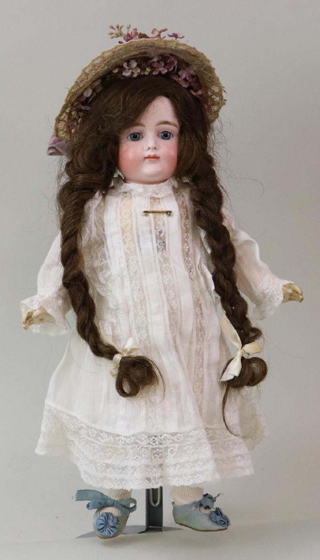 ANTIQUE BISQUE HEAD GERMAN DOLL.: 15" "X" Closed mouth pouty face doll with stationary blue eyes, long brown braided human hair wig, plaster pate. Rim edge marked (black ink) X11 or 11X. Papier mache ball jointed body with 1 pc. lower